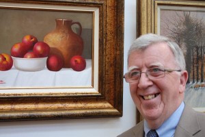 Artist Paul Kavanagh with one of his paintings at the exhibition opening (photo Liam Madden)