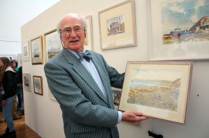 Artist Thomas Wilson with one of his paintings at the exhibition opening