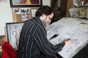 Oisin Roche with work on his graphic novel (photo Liam Madden)