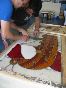 Working on a stained glass window.