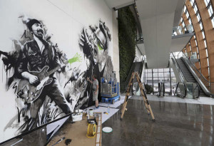 Fin Dac working on a U2 themed mural in the hotel